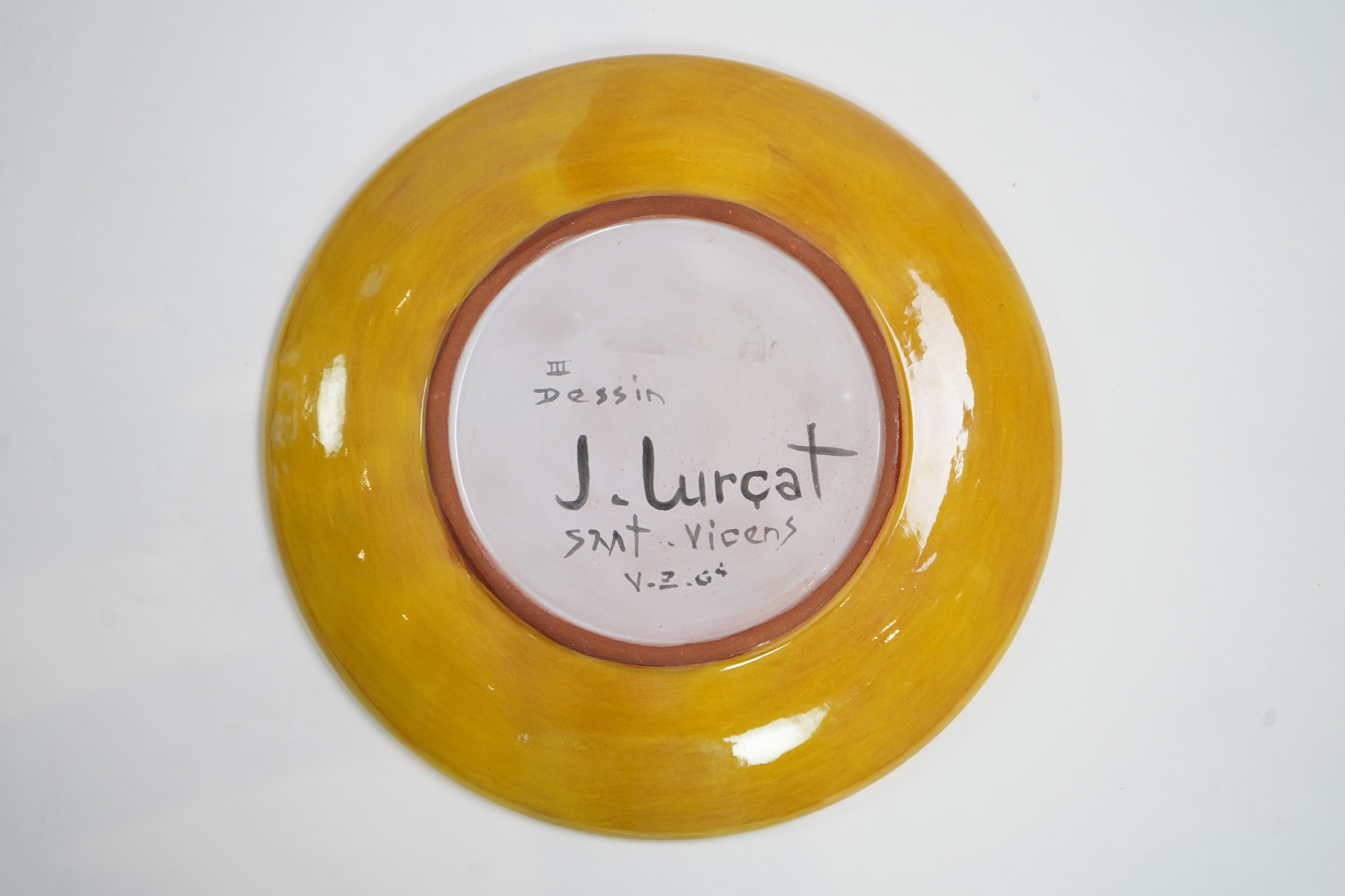 Jean Lurçat (1892-1966): A yellow glazed earthenware plate, decorated with a stylised central figure